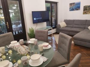a living room with a table and a couch at SUNSHINE CRIKVENICA in Crikvenica