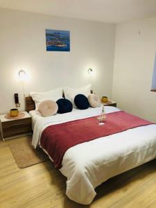 a bedroom with a large bed with pillows on it at Istrian stone house in the heart of the beautiful fishing village Fažana - only few steps from the sea and the wonderful beach - incl PLASMA-QUAD-PLUS-FILTER against C o v i d in Fažana