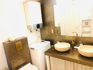 a bathroom with two sinks and a toilet at Istrian stone house in the heart of the beautiful fishing village Fažana - only few steps from the sea and the wonderful beach - incl PLASMA-QUAD-PLUS-FILTER against C o v i d in Fažana +29 photos