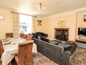 a living room with a couch and a table at The Barton in Bideford