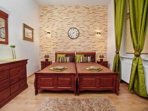 a bedroom with a bed with a clock on the wall at Apartament w Drawsku in Drawsko Pomorskie