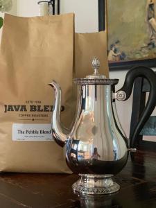 a tea kettle on a table next to a bag at The Pebble Bed and Breakfast in Halifax +11 photos