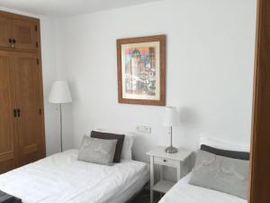 1 dormitorio con 2 camas y una foto en la pared en Belvilla by OYO Apartament Altea Mar, en Altea