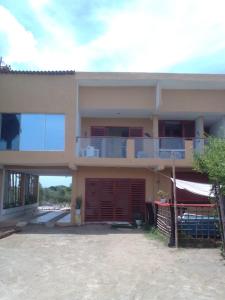 a large house with a balcony on top of it at Luna Roja casa Frente al Mar y glamping in San Onofre