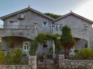 a large house with a tree on top of it at Kuća - vikendica in Kotor