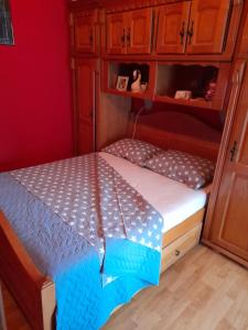 a bed in a small room with an umbrella on it at Kuća - vikendica in Kotor