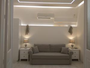 a living room with a couch and two lamps at NAFPAKTOS Beach luxury Suites in Nafpaktos