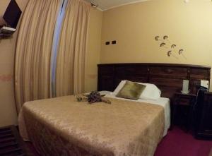A bed or beds in a room at Hotel Damian Park Hotel Delle Magnolie