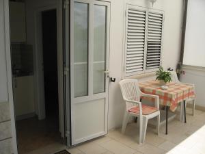 a room with a table and a chair and a door at Shell Bay Apartments in Korčula +26 photos