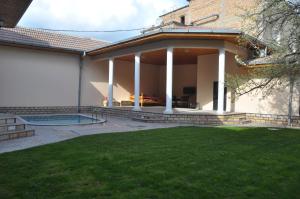 a house with a patio and a swimming pool at Hotel Samarkand Safar in Samarkand