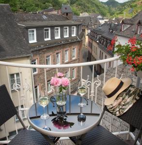 a balcony with a table and chairs on top of it at Hotel Germania in Cochem