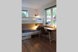 a room with a desk and a bunk bed at Cottage perfect for short time rent in Gustavsberg