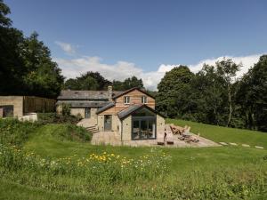 an old house on a hill with a green field at Hillside Cottage in Shaftesbury