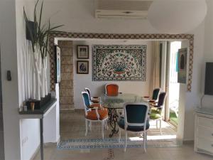 uma sala de jantar com mesa e cadeiras em Jasmin 4 em Netanya