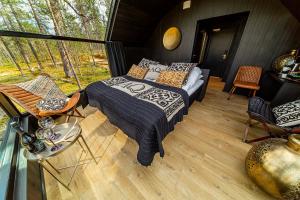 a bedroom with a bed and a balcony at Aurora Queen Resort Igloos in Saariselka