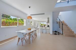 a dining room and kitchen with a table and chairs at Villa Mar in Alcudia