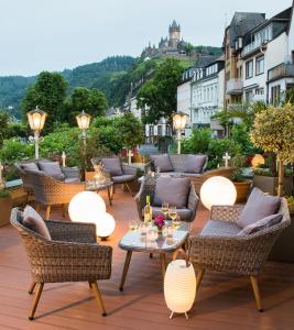a living room filled with tables and chairs with umbrellas at Hotel Germania in Cochem