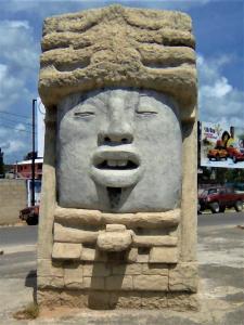 a statue of a face on the side of a street at Fully equipped 2 bedroom tree top cottage, with large balcony in private garden in San Ignacio