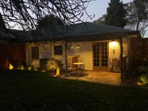 a house with a patio at night at Little Chelsea in Moss Vale
