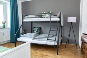 a bedroom with two bunk beds and a ladder at Ferienwohnung Panorama mit Festungsblick in Würzburg