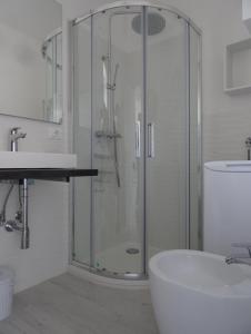 a bathroom with a glass shower and a sink at alcastello - Casamatta via Dante Alighieri,36 in Isola del Giglio