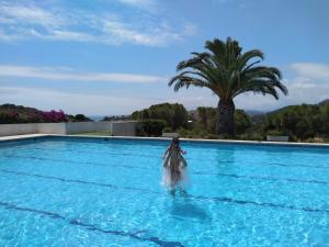 a woman is in the water in a swimming pool at Casa Morisca in Tossa de Mar