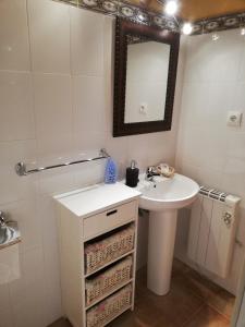 a white bathroom with a sink and a mirror at Casa Rural LA HUERTA DE POTES in Cabezón de Liébana +20 photos