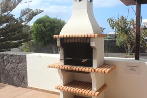 a small oven sitting on top of a wall at VILLA RAQUEL in Yaiza