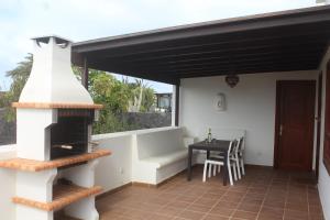 a patio with a wood stove and a table at VILLA RAQUEL in Yaiza