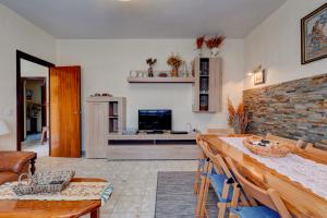 a living room with a table and a television at Finca Victoriana Riaza in Riaza