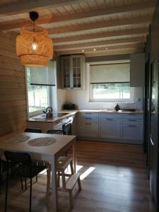 a kitchen with a table and chairs in a kitchen at Domek Ostoja rodzinna u Grzybka in Nadole