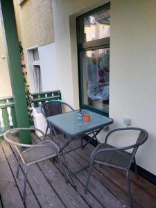 a blue table and two chairs on a balcony at Ferienwohnung Rickyy in Reichenbach im Vogtland