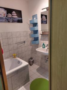 a bathroom with a tub and a sink at Ferienwohnung Rickyy in Reichenbach im Vogtland