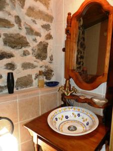 a bathroom with a sink and a stone wall at La torna in Navarredonda de Gredos +18 photos