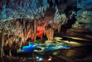 a cave with a pool of water in it at Guest House ELENA in Kutaisi