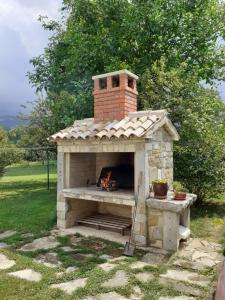a brick oven with a fire inside of it at Apartmani Aldo in Roč