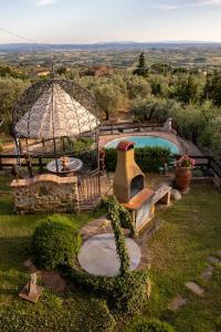 a garden with a gazebo and a swimming pool at Capitati...per caso in Vinci