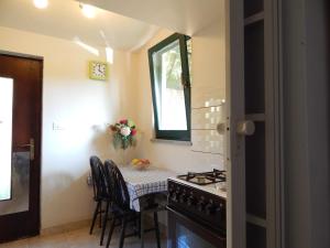 a kitchen with a stove and a table with chairs at Apartment Tomato in Pula