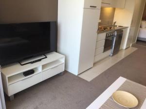 A television and/or entertainment center at Beachside Luxury Apartments One & Two Bedroom
