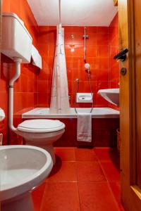a bathroom with a toilet and a sink at Hotel Cristallo in Courmayeur +33 photos