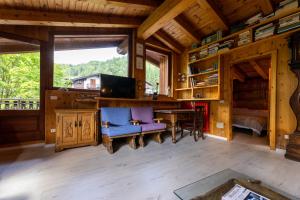 a room with a desk and a table and chairs at Hotel Cristallo in Courmayeur