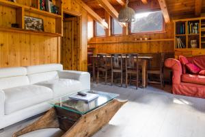 a living room with a white couch and a table at Hotel Cristallo in Courmayeur