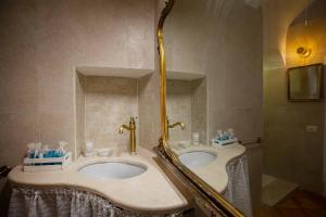 a bathroom with two sinks and a shower at Hostunia in Ostuni