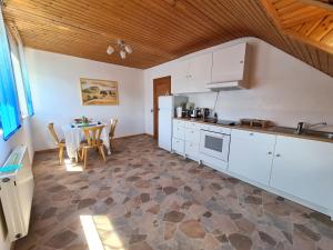 a kitchen with white cabinets and a table with chairs at Holzfeld in Boppard