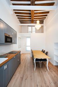 a kitchen with a wooden table and a dining room at Paris Place du Pantheon in Paris