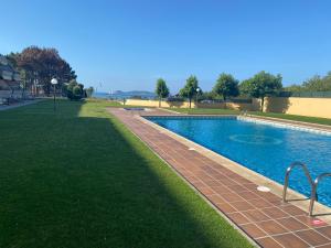 a swimming pool in a park with green grass at San Vicente do Mar , playa in Pontevedra