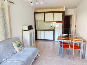 a kitchen and dining room with a table and chairs at Cala Galdana Beach in Cala Galdana