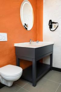 a bathroom with a sink and a toilet and a mirror at Acar Suite Hotel in Istanbul