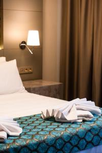 a hotel room with a bed with towels on it at Acar Suite Hotel in Istanbul +33 photos