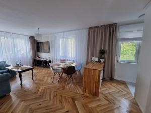 a living room with a table and a dining room at Apartament Józefa Bema - Gdynia Śródmieście in Gdynia